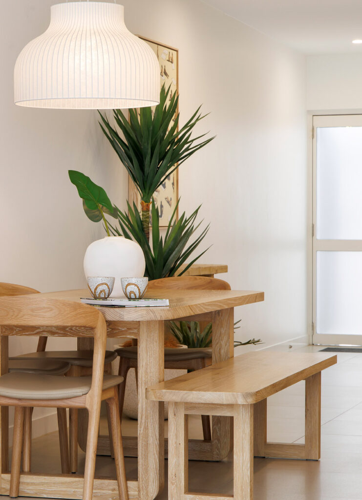 Modern dining area with plants and earthy colour tones